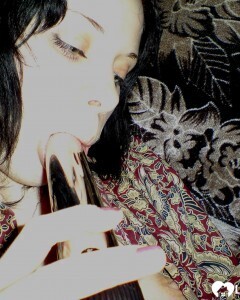 Smoking wife using a long metal dildo