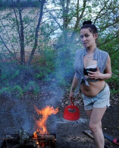 Barbecuing makes her hot so she strips