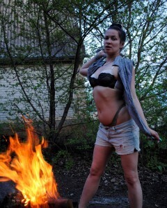 Barbecuing makes her hot so she strips