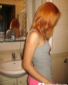 Redhead taking some hot selfies before showering