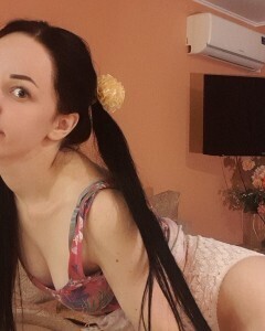Brunette with pigtails poses in knee socks