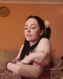 Brunette with pigtails poses in knee socks