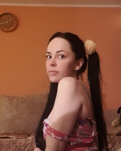 Brunette with pigtails poses in knee socks