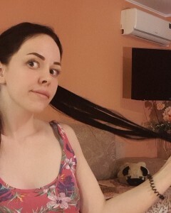 Brunette with pigtails poses in knee socks