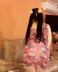 Brunette with pigtails poses in knee socks