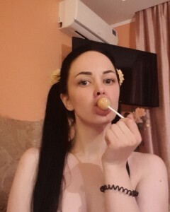 Brunette with pigtails poses in knee socks