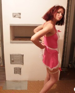Housewife posing in a sexy maid outfit