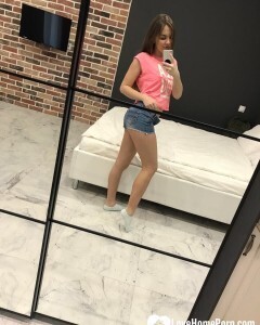 Horny teen plays with her phone while flashing