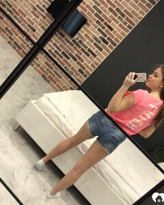 Horny teen plays with her phone while flashing