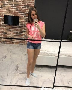 Horny teen plays with her phone while flashing