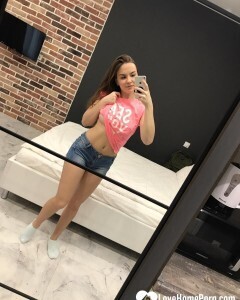 Horny teen plays with her phone while flashing