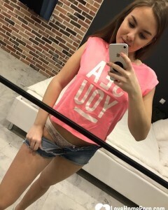 Horny teen plays with her phone while flashing