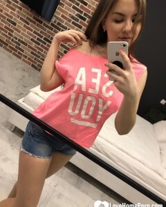 Horny teen plays with her phone while flashing