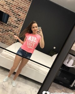 Horny teen plays with her phone while flashing