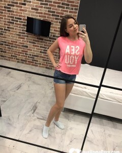 Horny teen plays with her phone while flashing