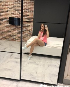 Horny teen plays with her phone while flashing