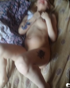 Luscious beauty with an ass tattoo fooling around