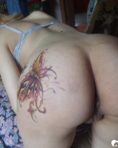 Luscious beauty with an ass tattoo fooling around