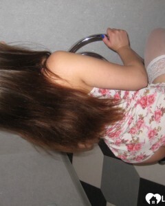 Brunette showing off her tattooed leg in stockings