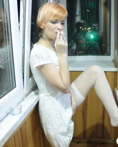 Hottie sits by the window in an outfit