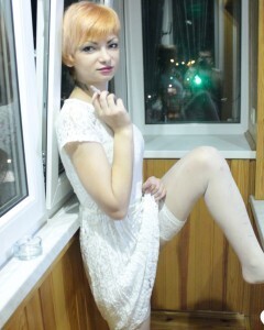 Hottie sits by the window in an outfit