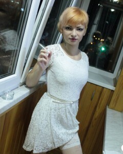 Hottie sits by the window in an outfit