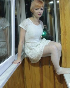 Hottie sits by the window in an outfit